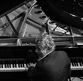 Monty at piano shot black and white.jpg